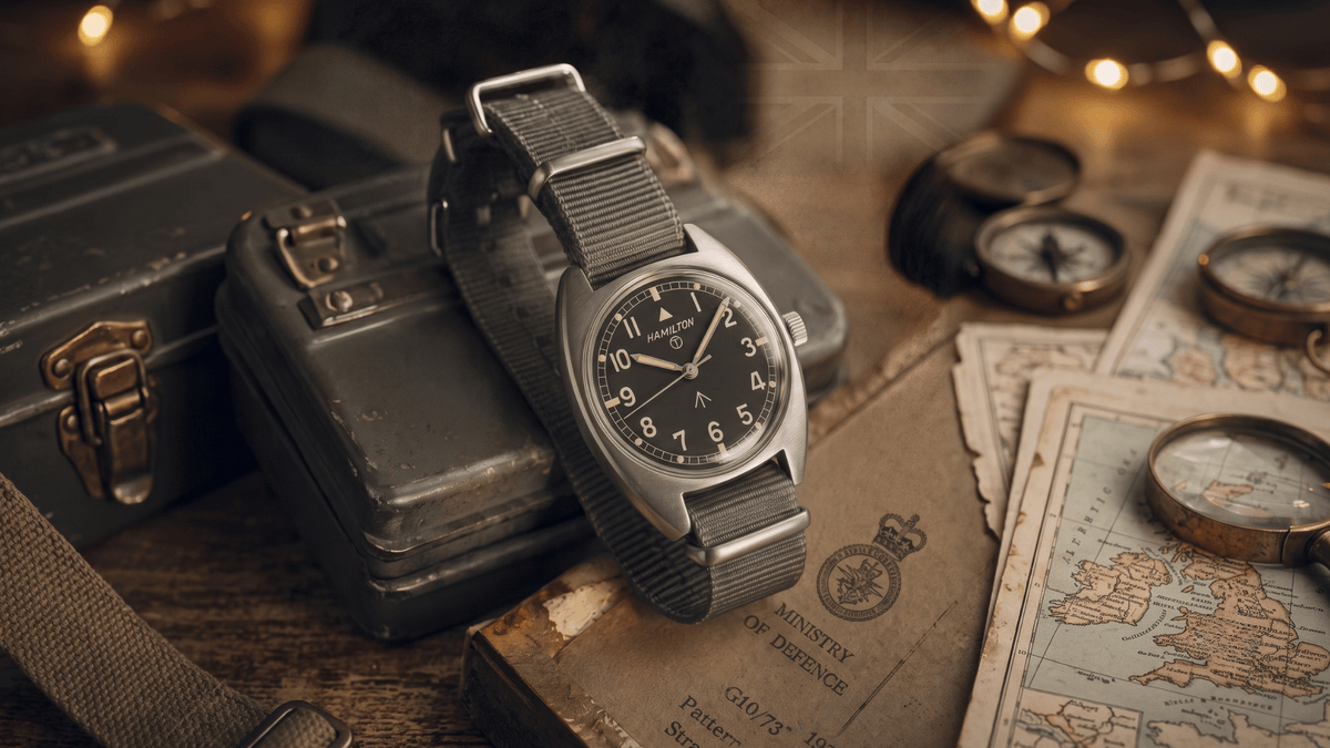 Grey NATO strap on a military field watch over British Ministry of Defence documents.
