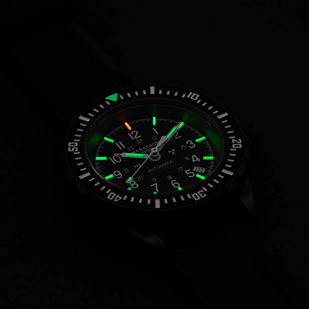 Marathon GSAR Automatic 41mm US Government Dial with green tritium lume glowing in low light on black rubber strap