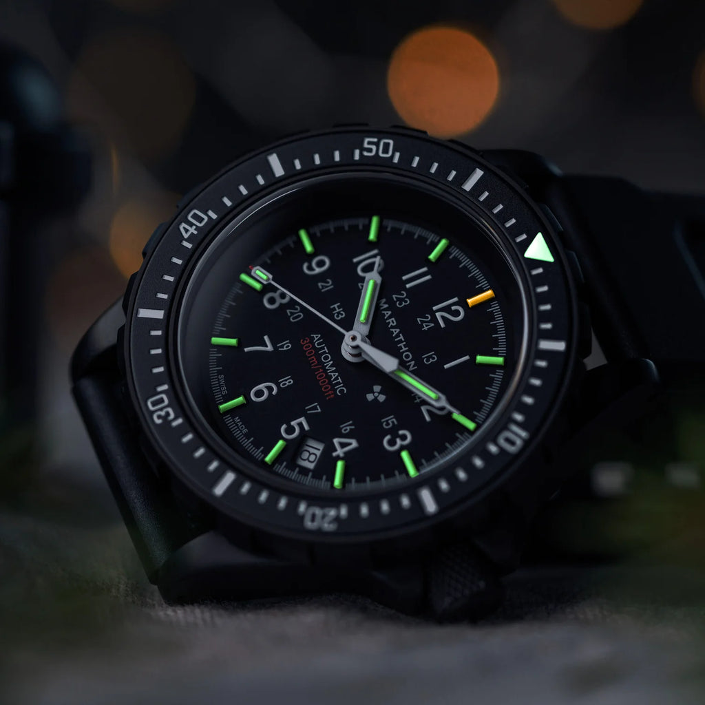 Marathon GSAR Automatic 41mm Anthracite Black watch with green and orange tritium glow in low light close up
