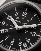 Close-up of the Marathon GPQ dial showing Tritium gas tubes and the Swiss-made 3-Jewel movement details. Professional military watch precision.