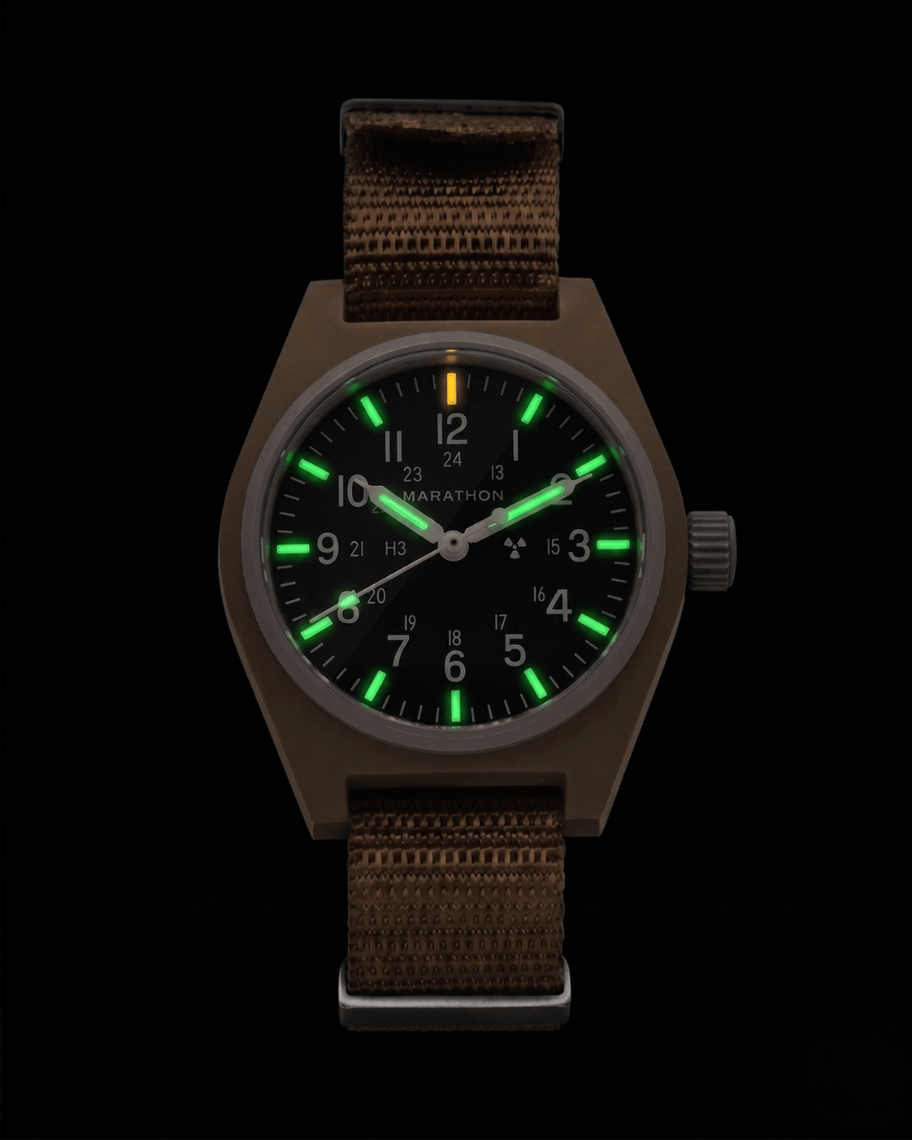Night view of the Marathon 34mm Desert Tan GPM. Self-powered Tritium gas tubes glowing on hands and markers for constant visibility. High-performance automatic military watch.