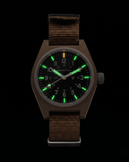 Night view of the Marathon 34mm Desert Tan GPM. Self-powered Tritium gas tubes glowing on hands and markers for constant visibility. High-performance automatic military watch.