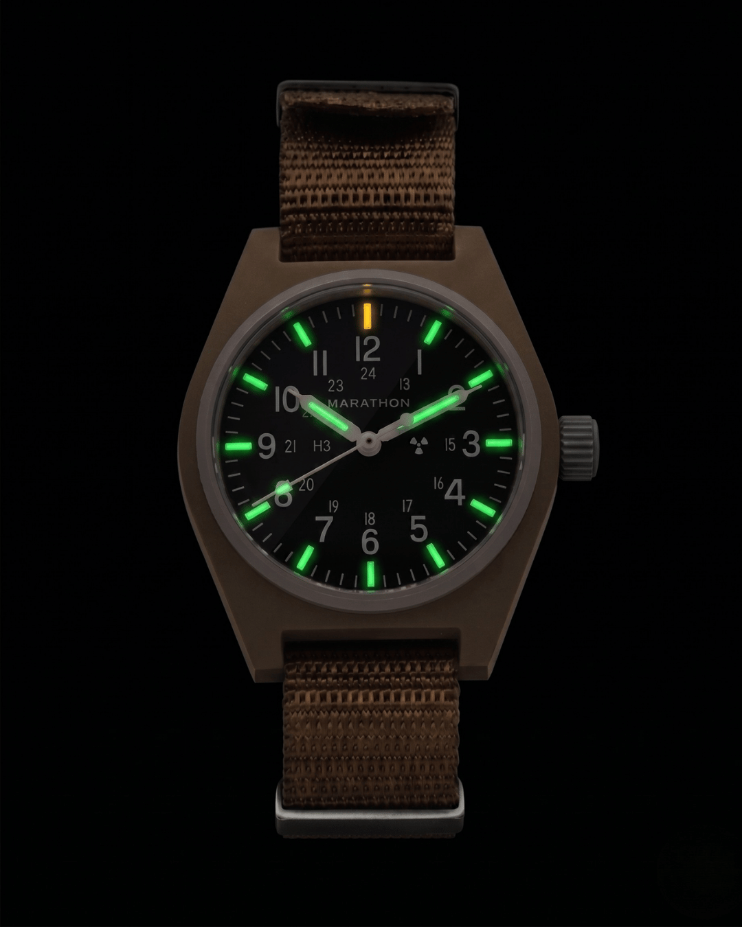 Night view of the Marathon 34mm Desert Tan GPM. Self-powered Tritium gas tubes glowing on hands and markers for constant visibility. High-performance automatic military watch.
