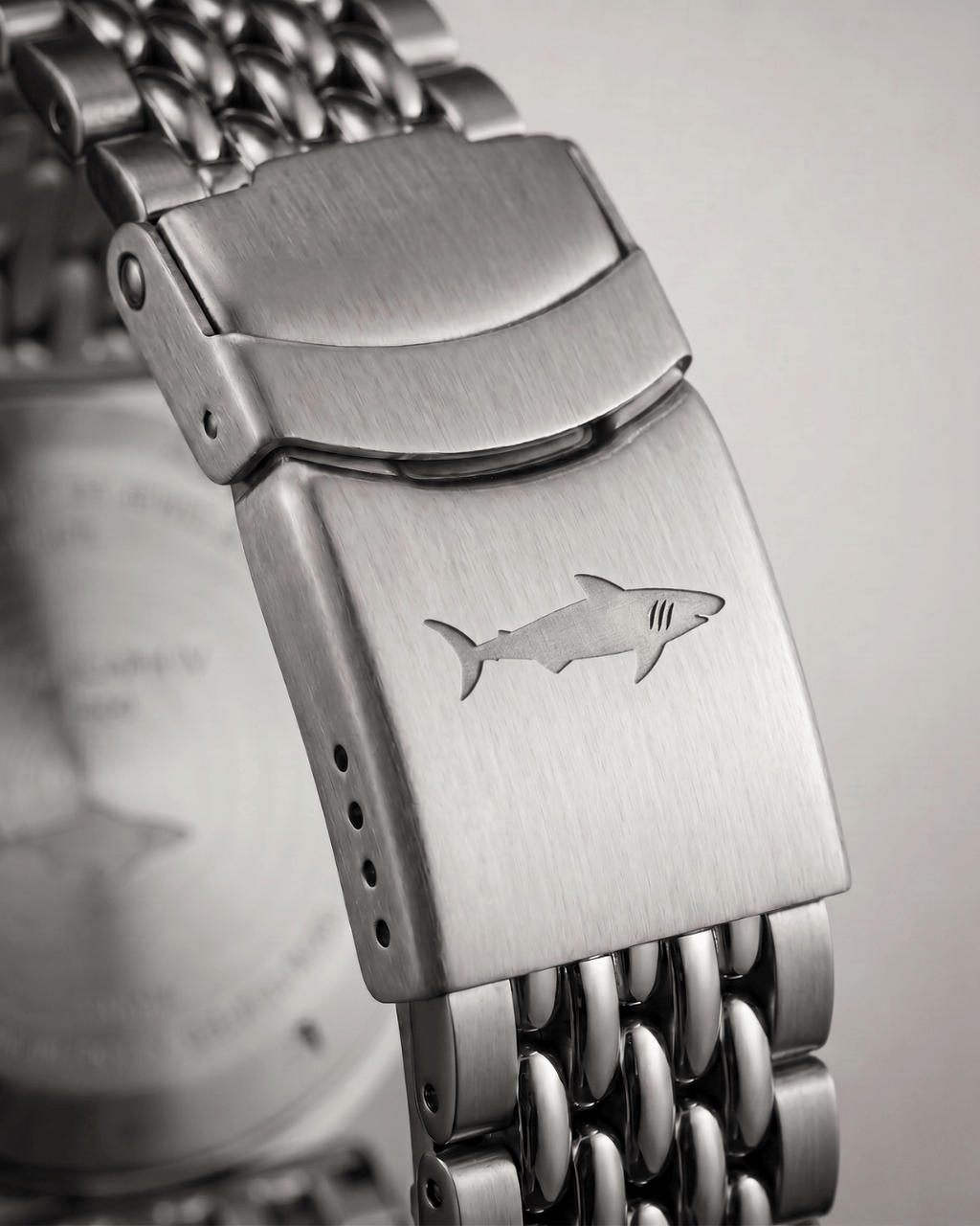 Stainless steel clasp of an Alsta dive watch featuring a minimalist shark engraving.