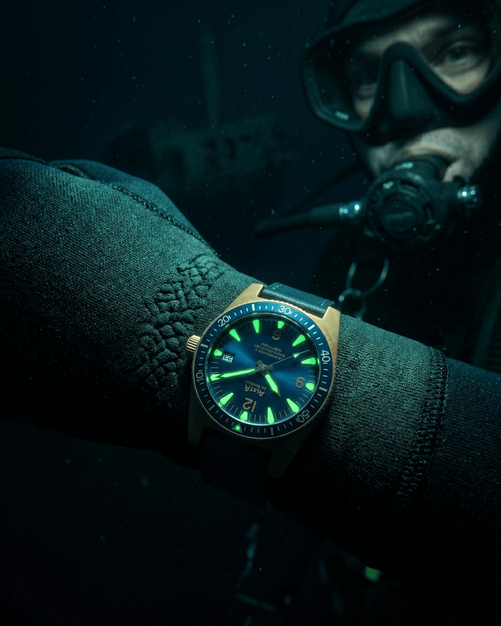 Alsta watches Nautoscaph bronze dive watch worn over a wetsuit during professional diving.