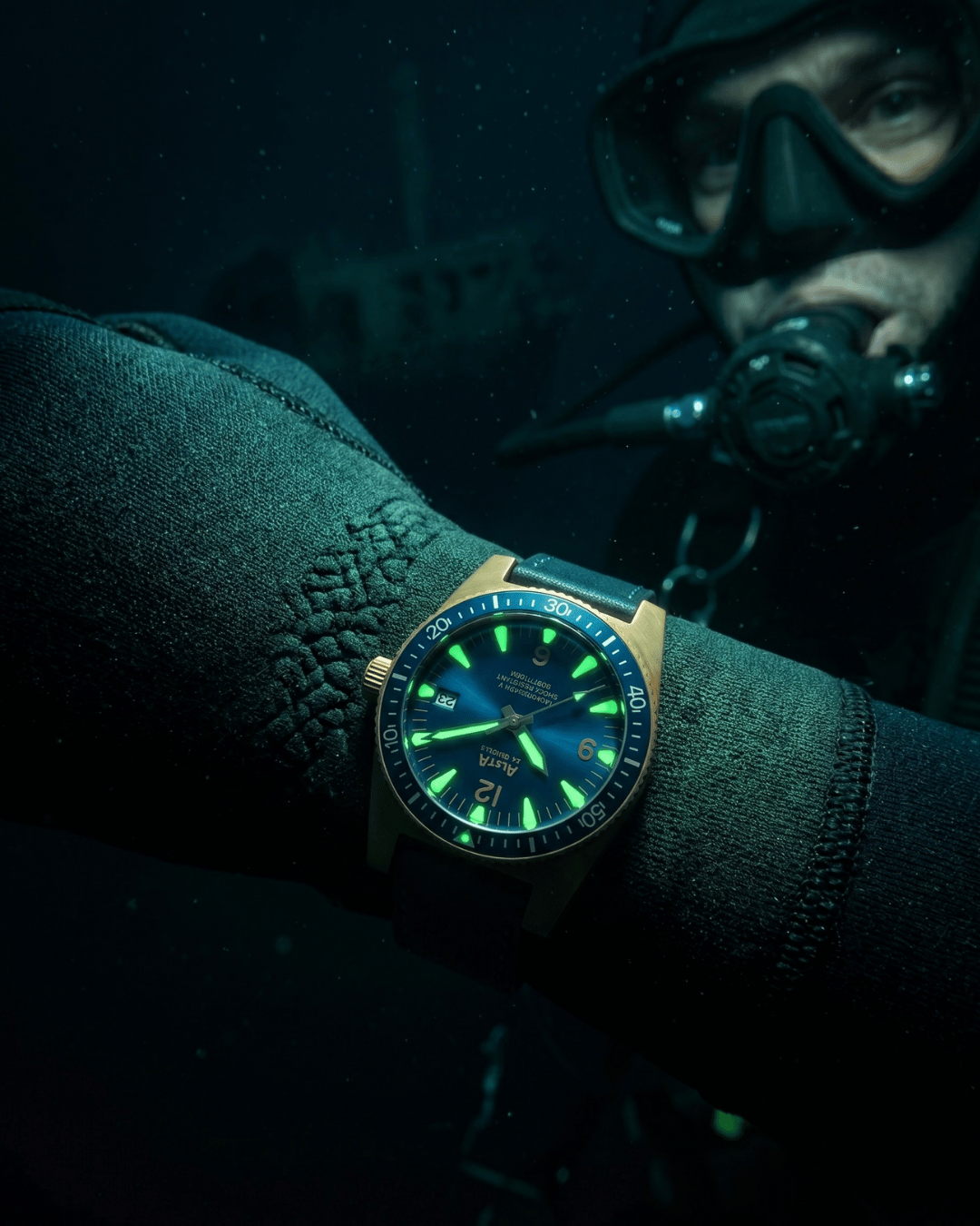 Alsta watches Nautoscaph bronze dive watch worn over a wetsuit during professional diving.