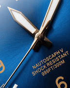 Close-up of Alsta watches deep blue dial showing rose gold hands and sapphire crystal.