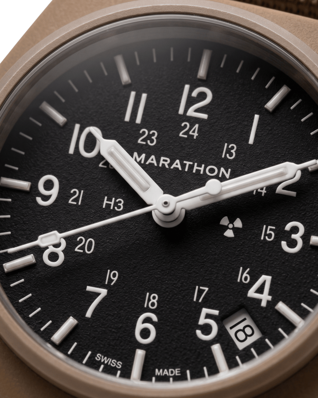 Close-up of the 34mm GPQ-D Tritium dial. Swiss quartz watches for men nearby at Tempohaus.