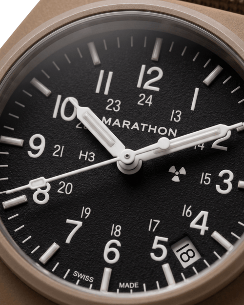 Close-up of the 34mm GPQ-D Tritium dial. Swiss quartz watches for men nearby at Tempohaus.